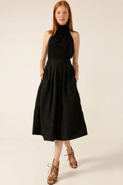 A model wearing the Pleated Ain colourLine Skirt - Black (Black), from the front, showing the whole outfit