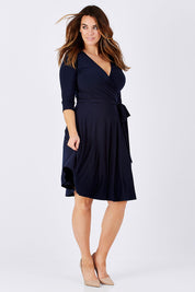 Model Laura wearing size 12 of the Reverse Wrap Full Skirt Dress in colour Navy (Blue), from the front, showing the whole outfit
