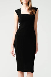 A model wearing the Iris Cap Sleeve Dress in colour Black (Black), from the front, cropped image