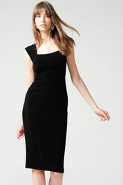A model wearing the Iris Cap Sleeve Dress in colour Black (Black), from the front, cropped image