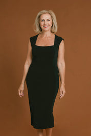 Model Sandy wearing size 10 of the Iris Cap Sleeve Dress in colour Black (Black), from the front, cropped image