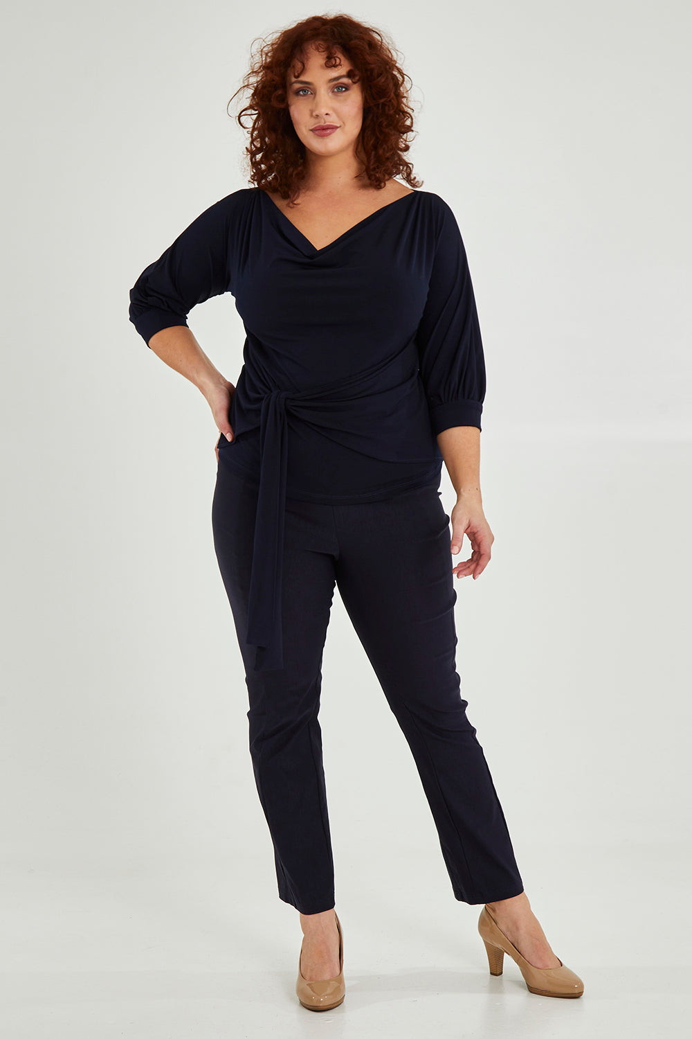 Model Maddy wearing size 16 of the Skinny Pant in colour Navy (Blue), from the front, showing the whole outfit
