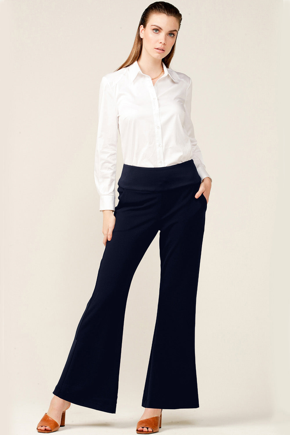 A model wearing the Classic Trouser in colour Navy (Blue), from the front, showing the whole outfit