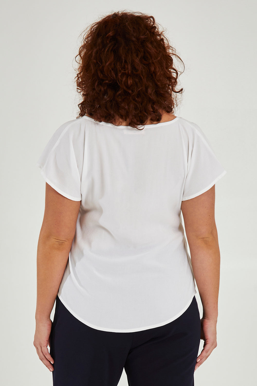 Model Maddy wearing size 16 of the Analia Top in colour White (White), from the back