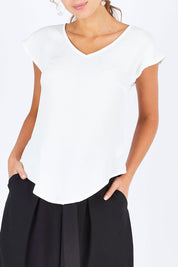 Model Madeline wearing size 10 of the Analia Top in colour White (White), from the front, cropped image