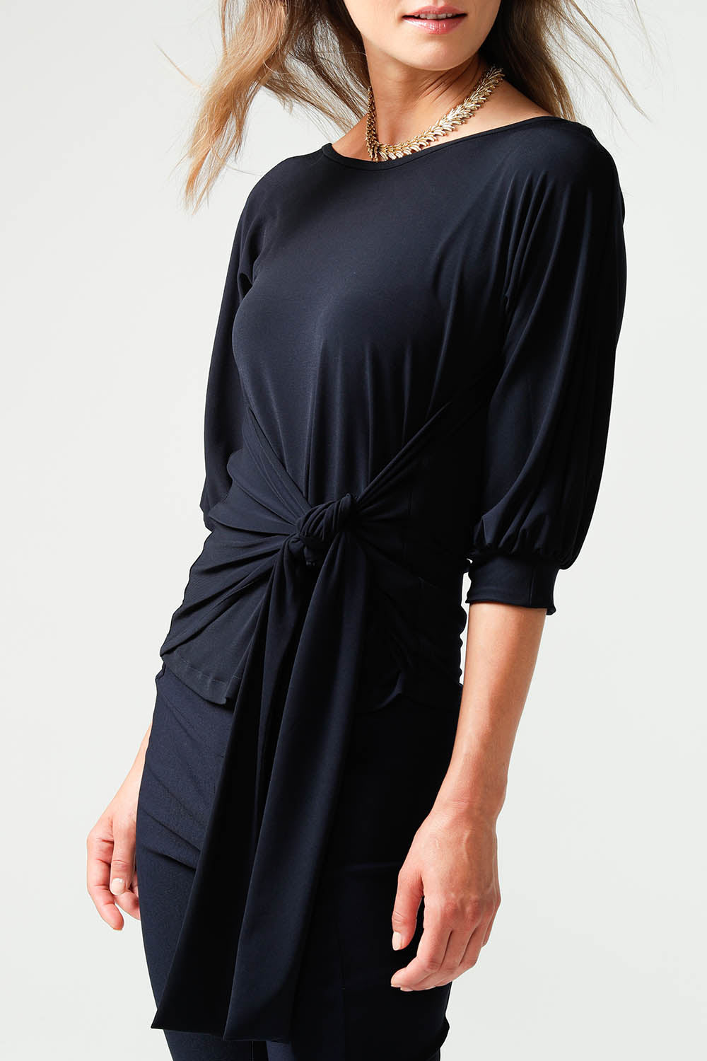 A model wearing the Cowl Tie Top in colour Navy (Blue), from the front, cropped image