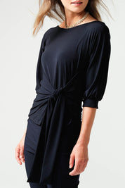 A model wearing the Cowl Tie Top in colour Navy (Blue), from the front, cropped image