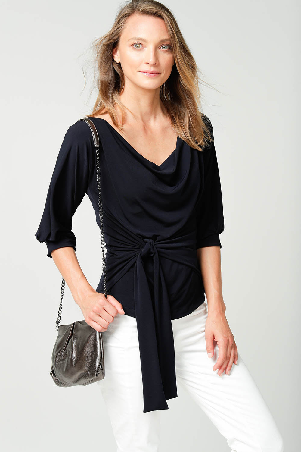 A model wearing the Cowl Tie Top in colour Navy (Blue), from the front, cropped image