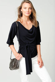 A model wearing the Cowl Tie Top in colour Navy (Blue), from the front, cropped image