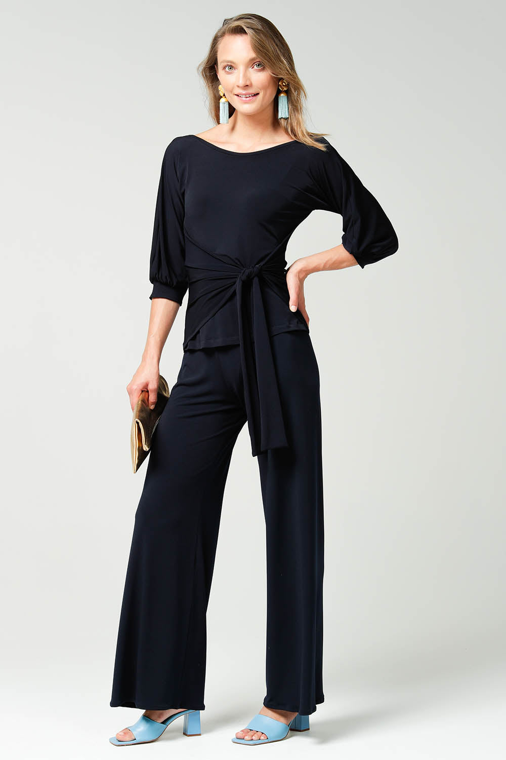 A model wearing the Cowl Tie Top in colour Navy (Blue), from the front, showing the whole outfit