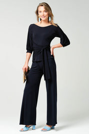 A model wearing the Cowl Tie Top in colour Navy (Blue), from the front, showing the whole outfit