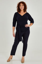 Model Maddy wearing size 16 of the Cowl Tie Top in colour Navy (Blue), from the front, showing the whole outfit