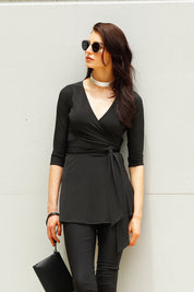 A model wearing the Turn around Tunic in colour Black (Black), from the front, showing the whole outfit