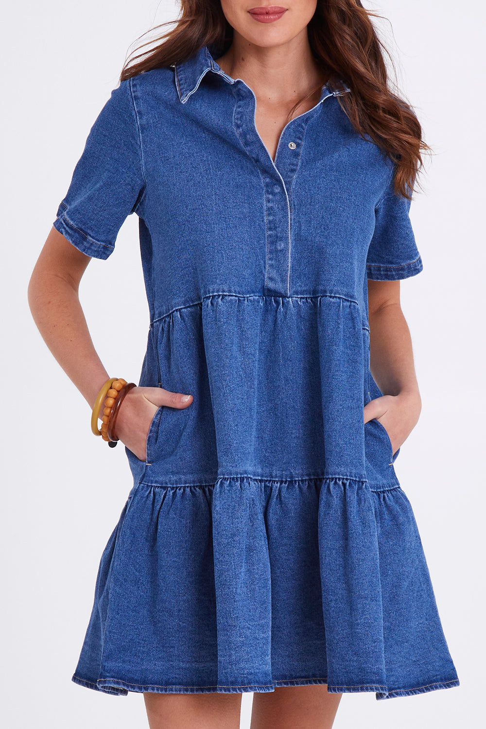 Model Madeline wearing size 10 of the Kellie Denim Dress in colour 80Wash (Blue), from the front, cropped image