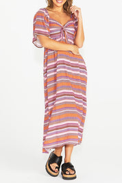 A model wearing the Raquel Midi Dress in colour Aztec (Pink), from the front, cropped image
