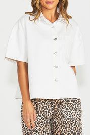 A model wearing the Wyatt Short Sleeve Denim Shirt in colour White (White), from the front, cropped image