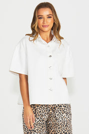 A model wearing the Wyatt Short Sleeve Denim Shirt in colour White (White), from the front, cropped image
