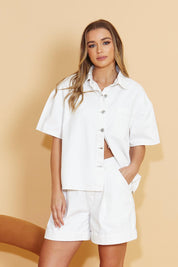 A model wearing the Wyatt Short Sleeve Denim Shirt in colour White (White), from the front, showing the whole outfit