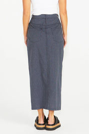 A model wearing the Liberty Cotton Maxi Skirt in colour Navy (Blue), from the back