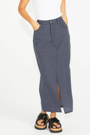 A model wearing the Liberty Cotton Maxi Skirt in colour Navy (Blue), from the front, cropped image