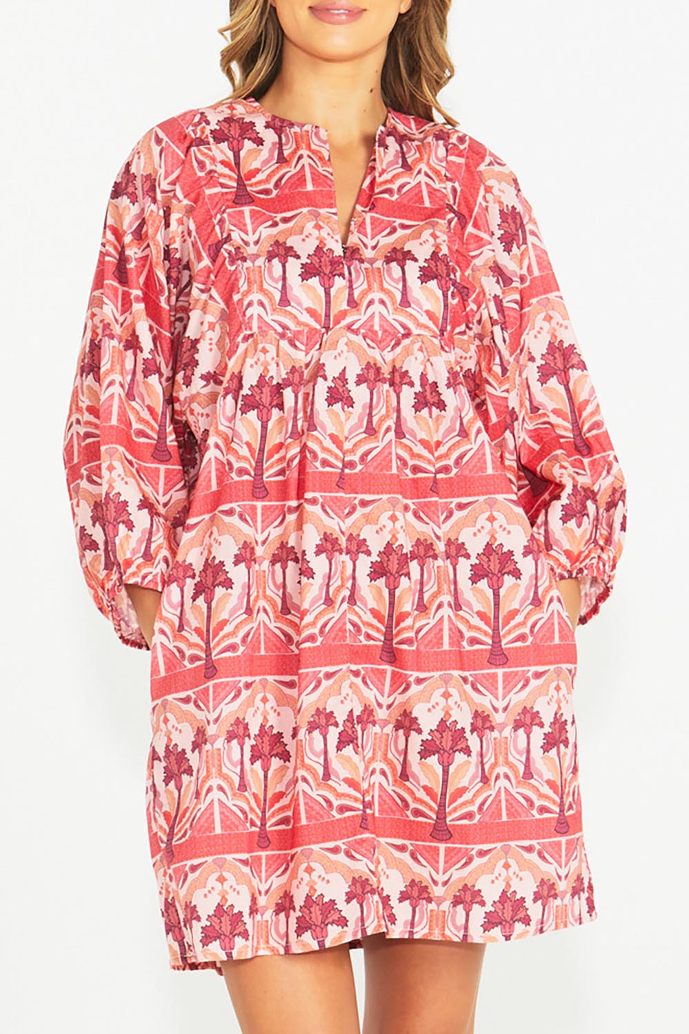 A model wearing the Zayda Cotton Dress in colour Arabian (Pink), from the front, cropped image