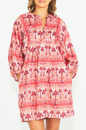 A model wearing the Zayda Cotton Dress in colour Arabian (Pink), from the front, cropped image