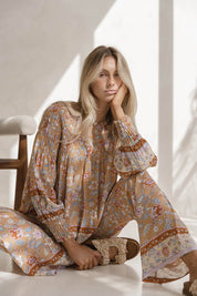 A model wearing the Margie Top in colour Paisley, from the front, showing the whole outfit