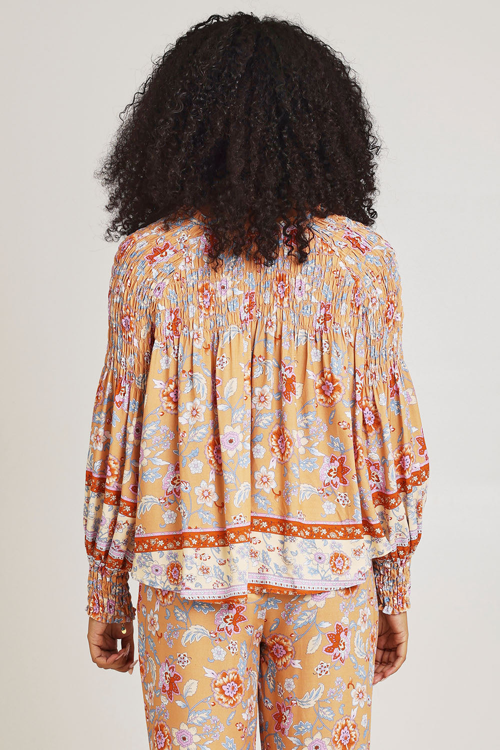 Model Ziara wearing size 10 of the Margie Top in colour Paisley, from the back
