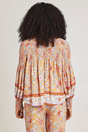 Model Ziara wearing size 10 of the Margie Top in colour Paisley, from the back