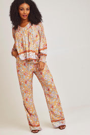 Model Ziara wearing size 10 of the Margie Pant in colour Paisley, from the front, showing the whole outfit