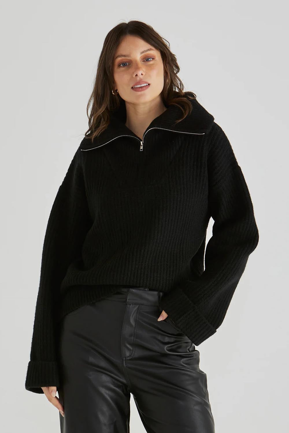 A model wearing the Bennett Knit Jumper in colour Black (Black), from the front, cropped image