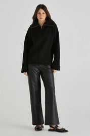 A model wearing the Bennett Knit Jumper in colour Black (Black), from the front, showing the whole outfit