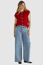 A model wearing the Zadie Vest in colour Poppyred (Red), from the front, showing the whole outfit