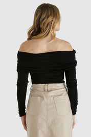 A model wearing the Caprice Top in colour Black (Black), from the back