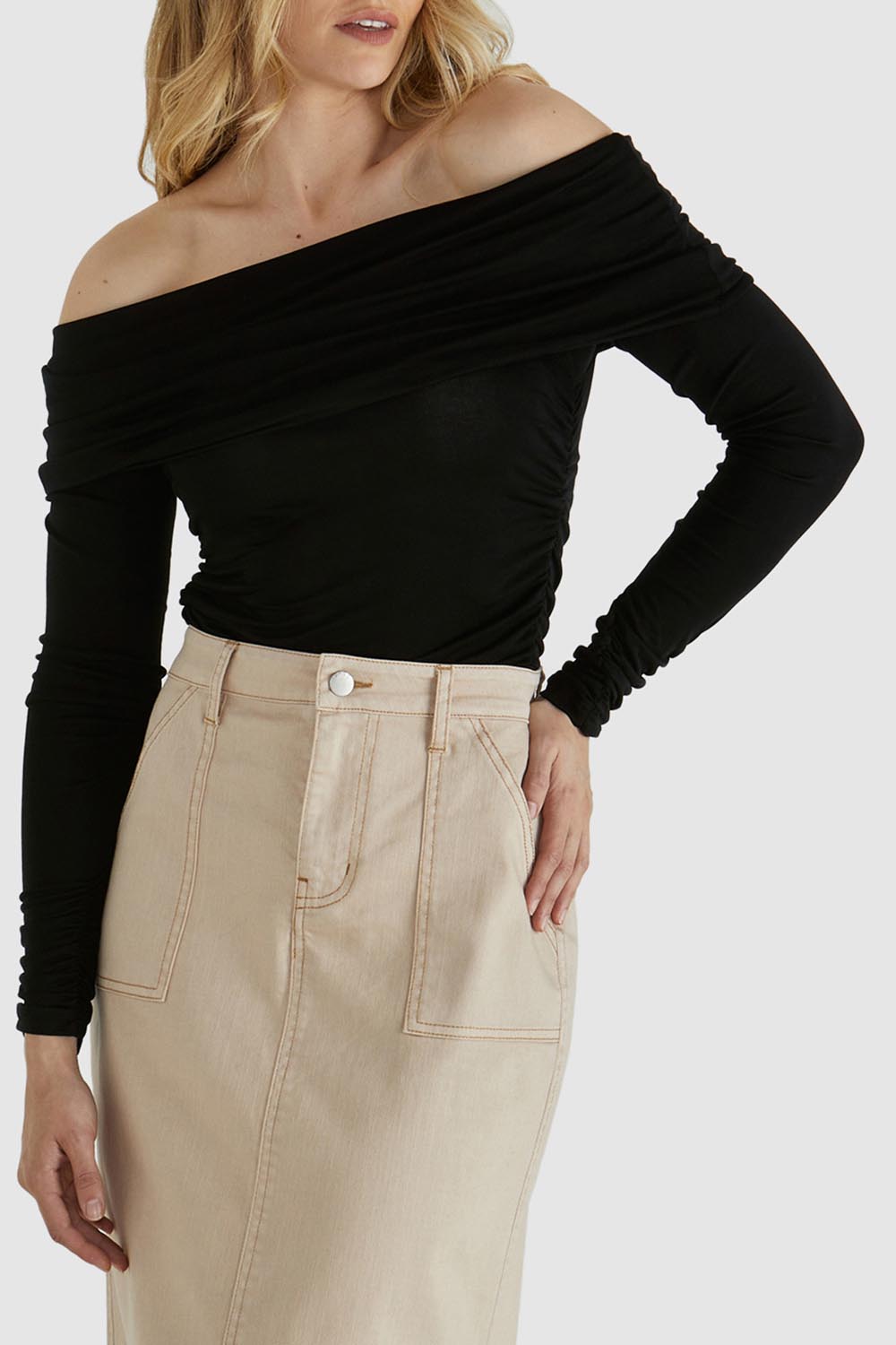 A model wearing the Caprice Top in colour Black (Black), from the front, cropped image