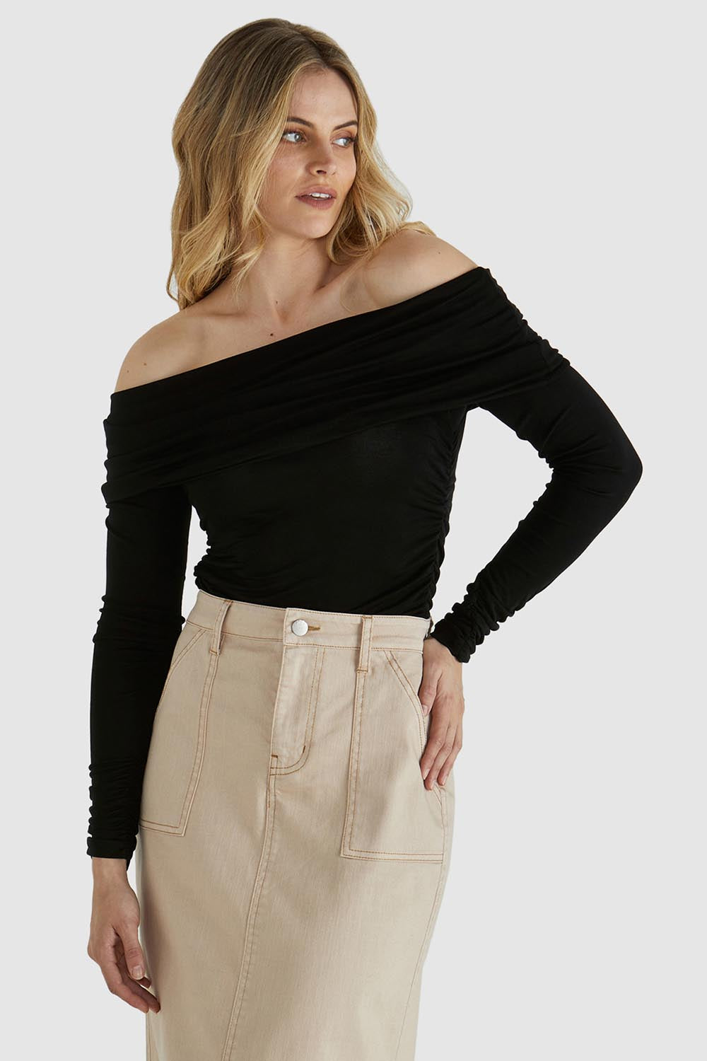 A model wearing the Caprice Top in colour Black (Black), from the front, cropped image