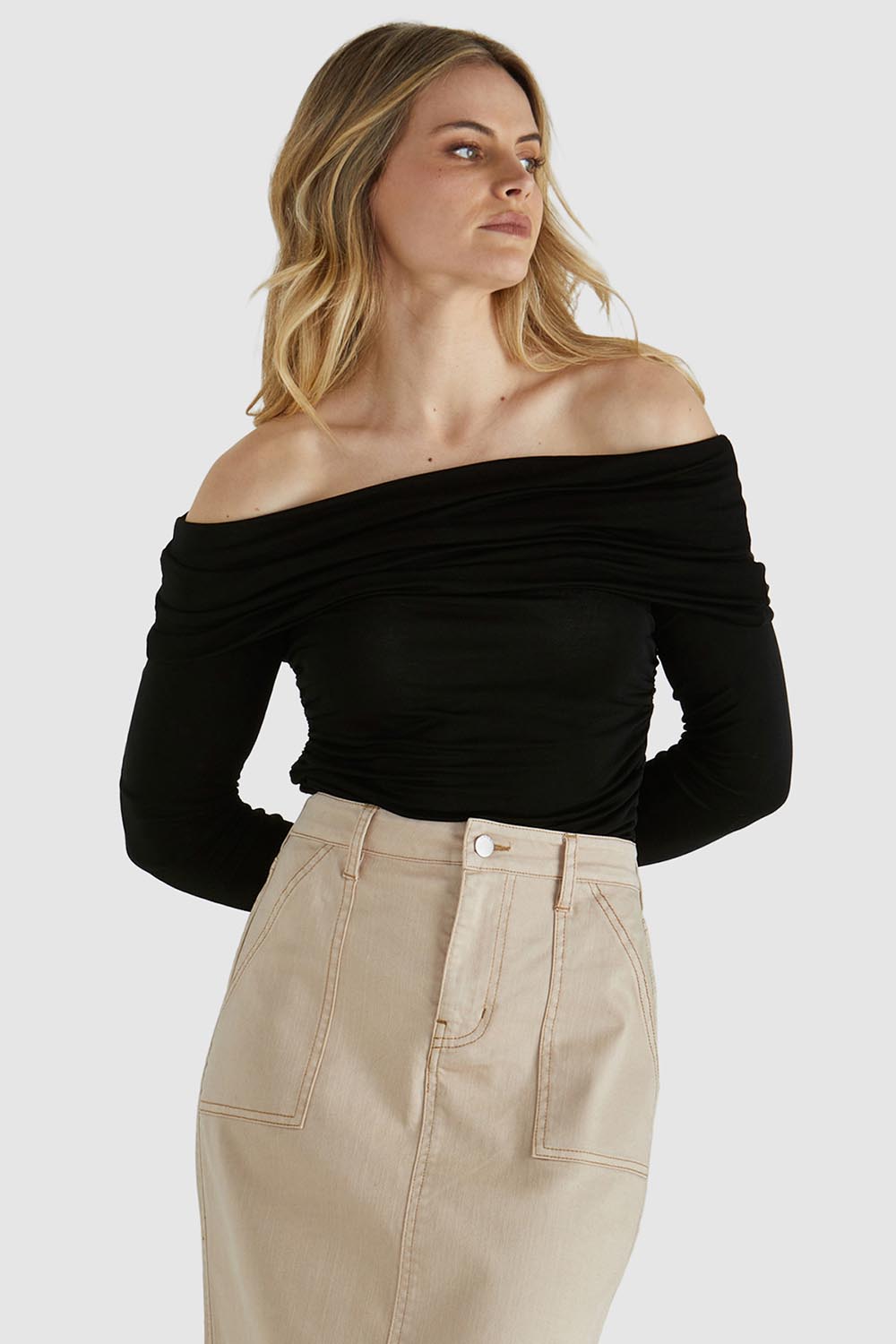 A model wearing the Caprice Top in colour Black (Black), from the front, cropped image