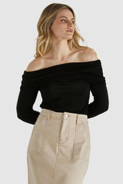 A model wearing the Caprice Top in colour Black (Black), from the front, cropped image