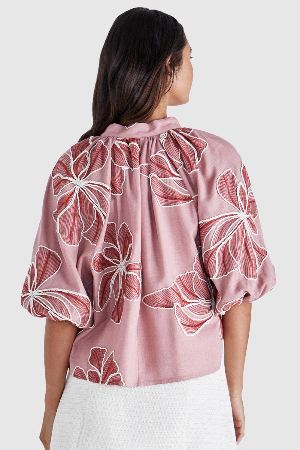A model wearing the Finley Top in colour Pinkred (Pink), from the back