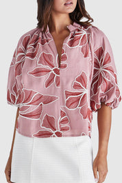 A model wearing the Finley Top in colour Pinkred (Pink), from the front, cropped image