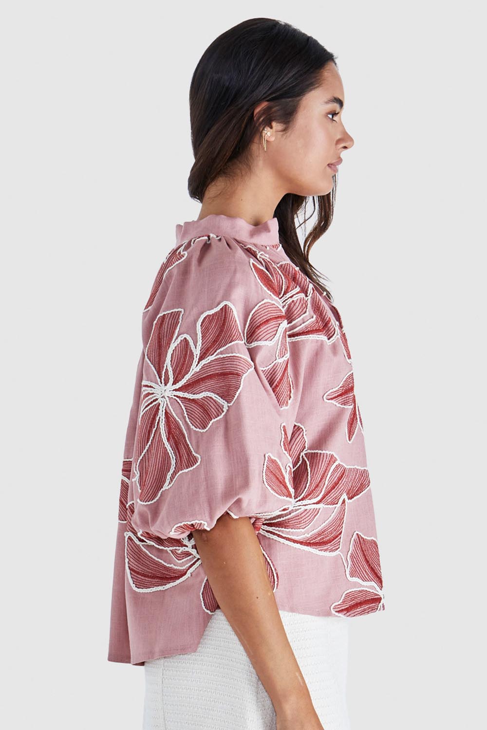 A model wearing the Finley Top in colour Pinkred (Pink), from the front, cropped image