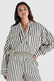 A model wearing the Rohan Cotton Top in colour Stripe, from the front, cropped image