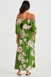 A model wearing the Antonie Off Shoulder Dress in colour Moonflower (Green), from the back