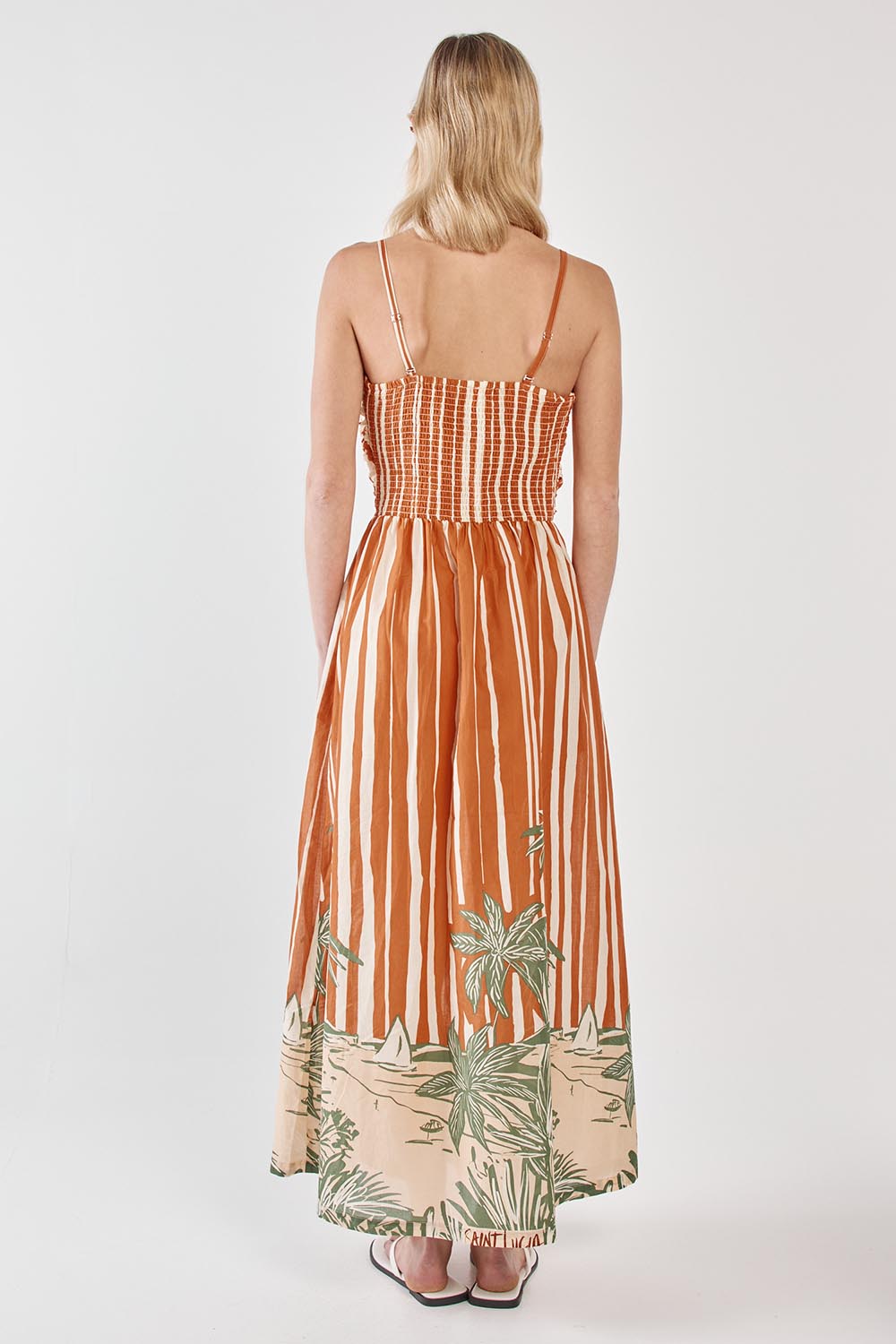A model wearing the Mina Cotton Strapless Dress in colour Palmstripe, from the back