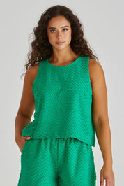 A model wearing the Codi Cotton Blend Tank in colour Green (Green), from the front, cropped image
