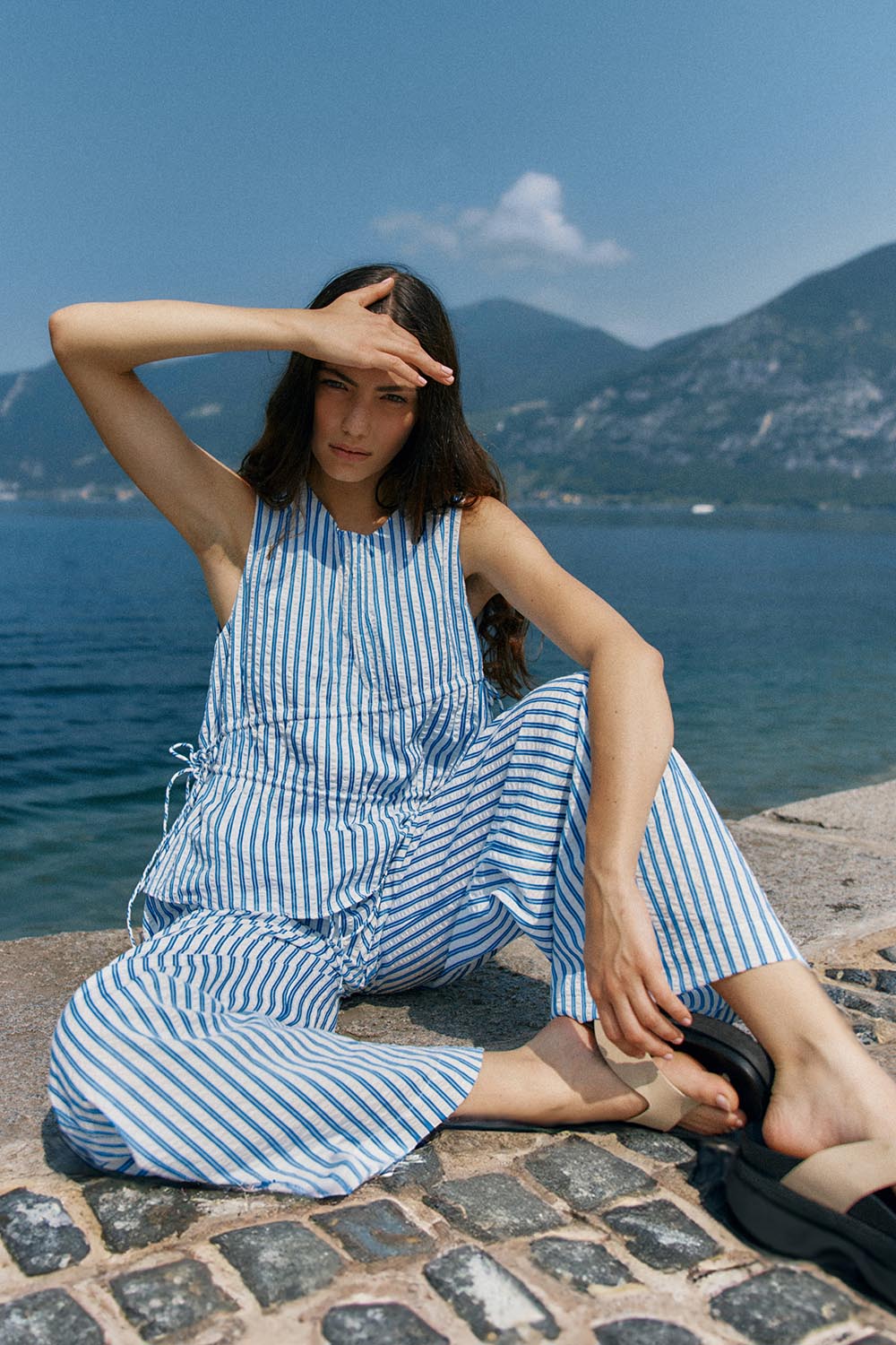 A model wearing the Aziza Pant in colour Bluewhite (Blue), from the front, showing the whole outfit