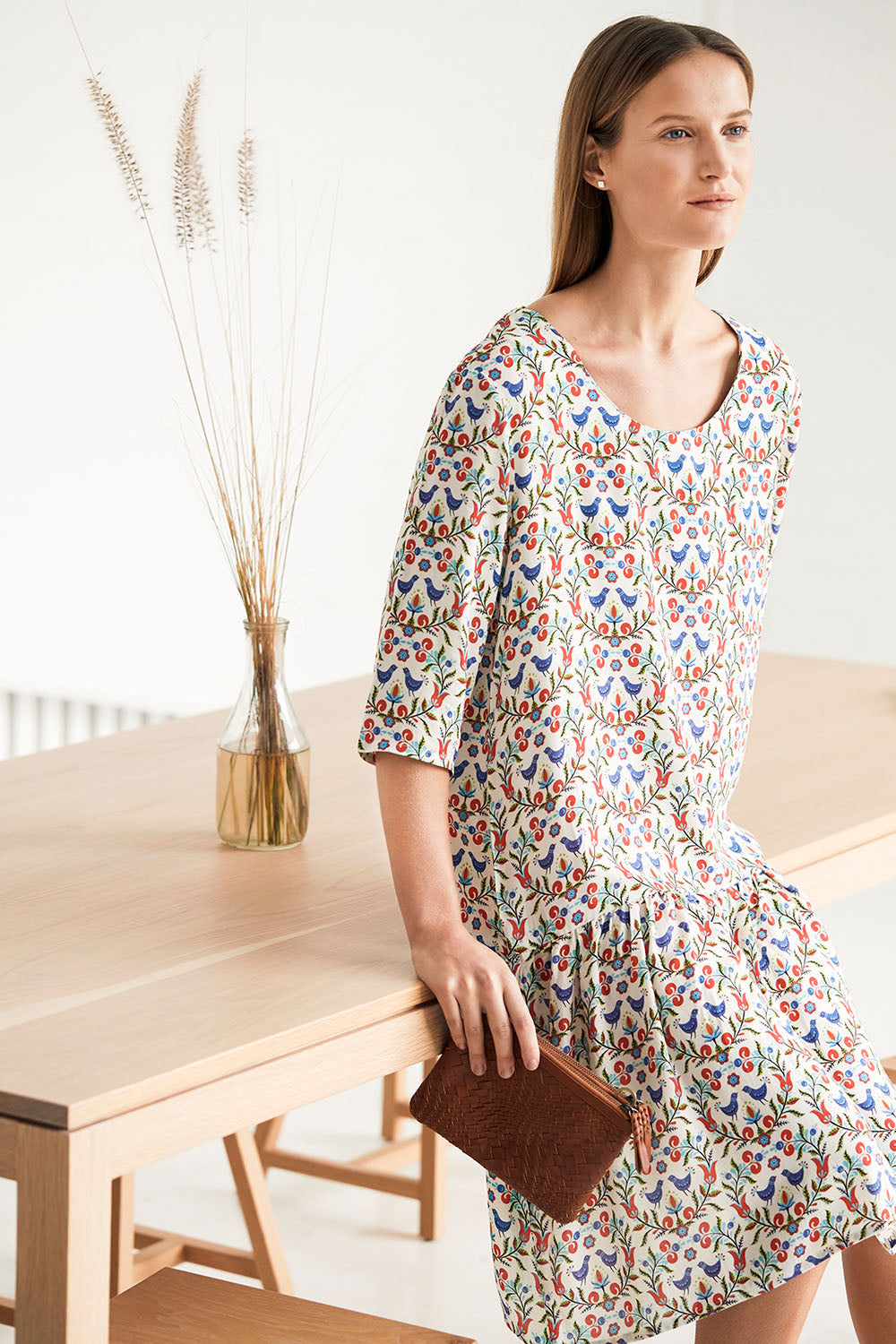 Model Johanna wearing size 10 of the Hygge Drop Waist Dress in colour RedBird (White), from the front, showing the whole outfit