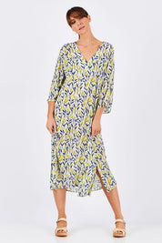 Model Monique wearing size 10 of the Manstrale Midi Dress in colour Petals (White), from the front, showing the whole outfit