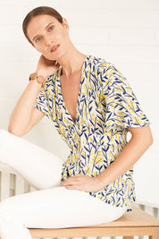 Model Johanna wearing size 10 of the Tystnad Blouse in colour YellowPtl, from the front, showing the whole outfit