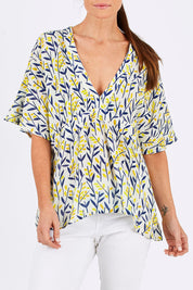 Model Monique wearing size 10 of the Tystnad Blouse in colour YellowPtl, from the front, cropped image
